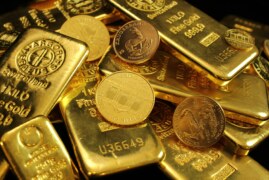 Gold inches lower as US yields, dollar rise on strong data